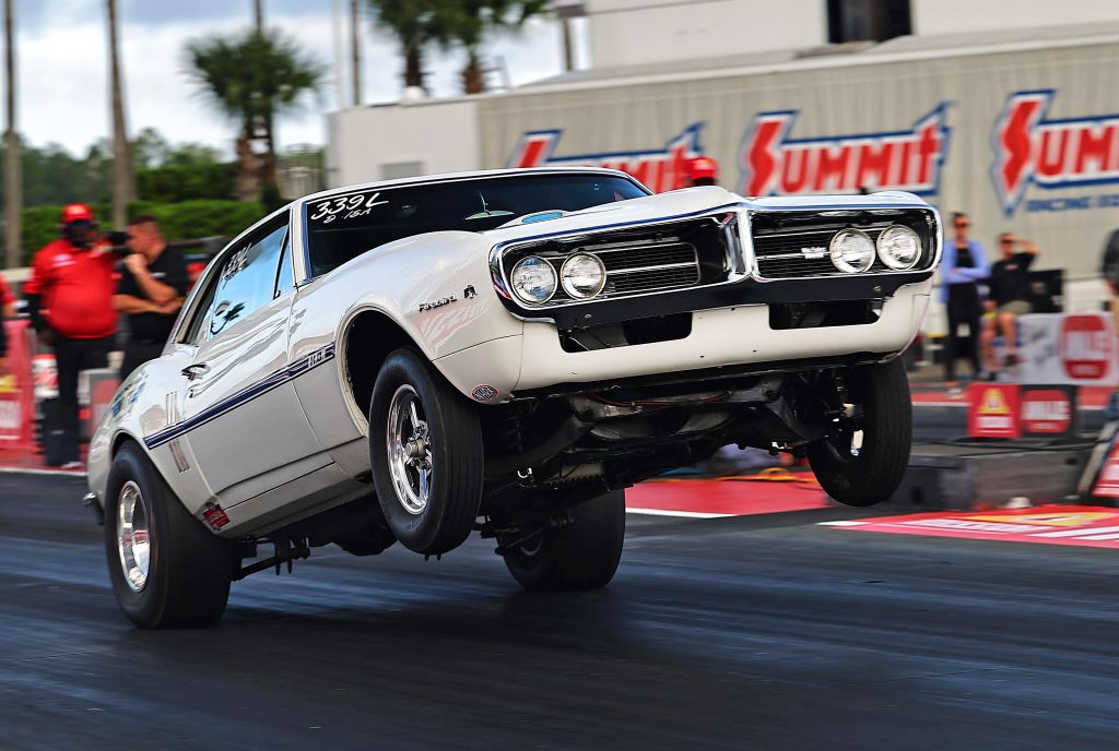 vintage pontiac firebird wheelstand at drag race