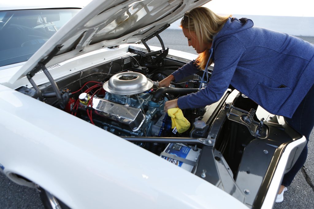 mechanic working on a race car engine