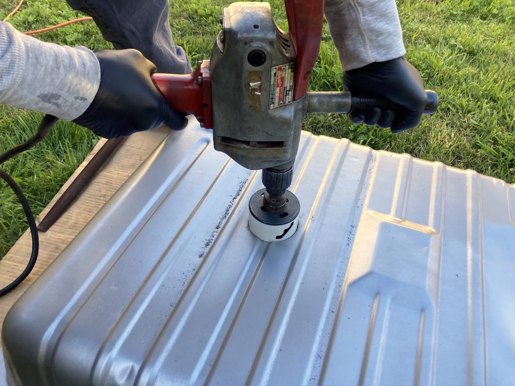 using hole saw to cut pump mounting spot in fuel tank