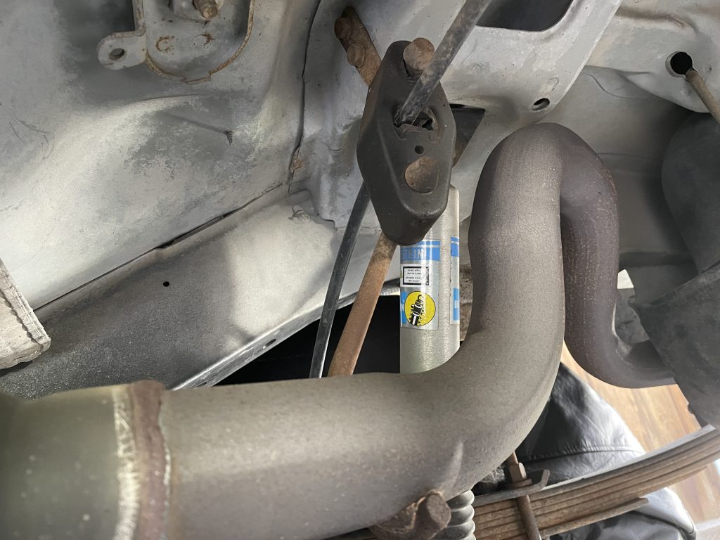rubber exhaust hanger with brake cable routing