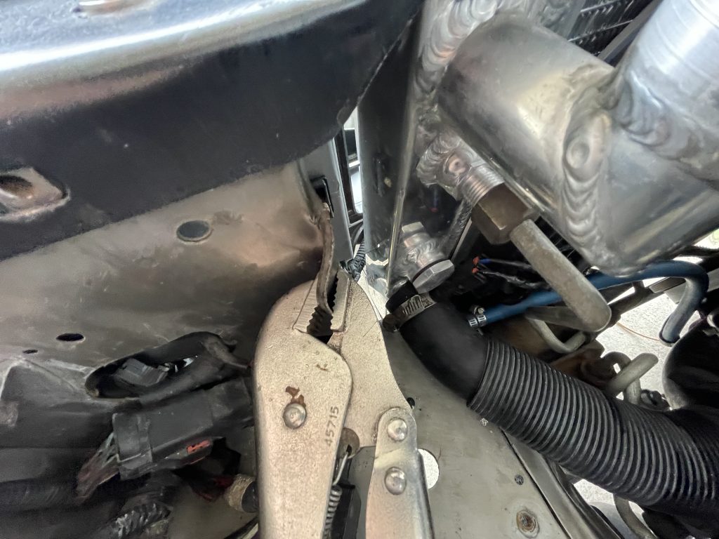 vice grips bending a tab on a metal bracket