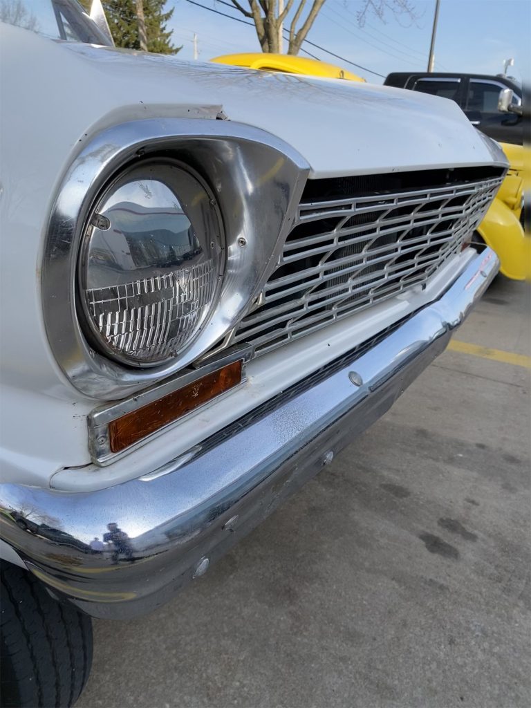Close up of headlight bezel on a vintage chevy ii nova gasser