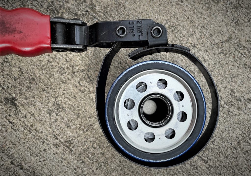 oil filter wrench placed around oil filter