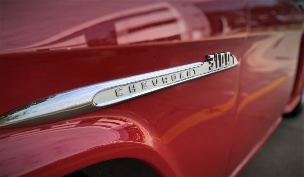 close up of 3100 fender emblem on a 1955 chevy task force truck
