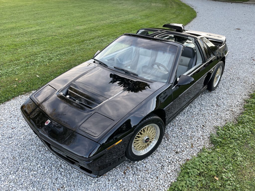 Freshly Detailed Black Pontiac Fiero in Driveway