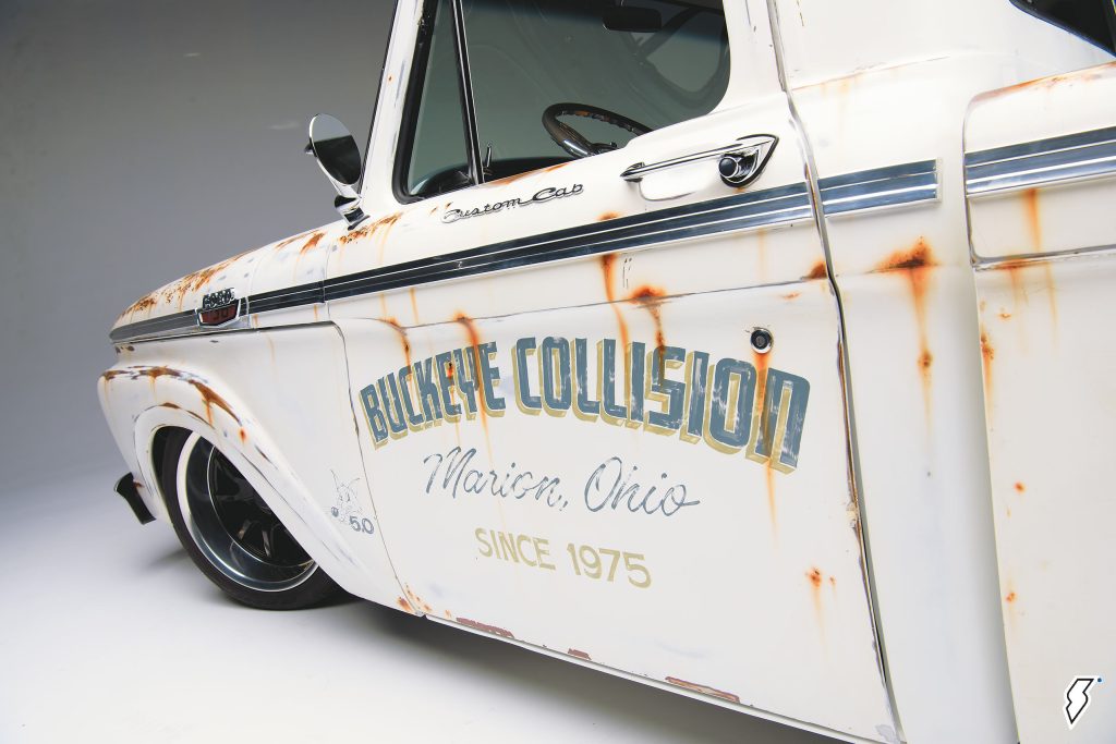 vintage body shop livery on side of a pickup truck