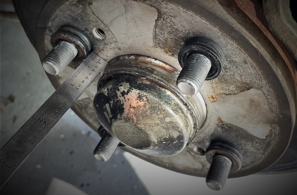 stack of washers on a wheel stud for wheel spacer size test