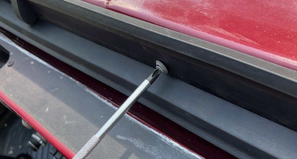 screwing a fastener into a weather-strip seal